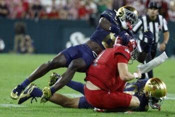 Sep 6, 2026; Green Bay, Wisconsin, USA;  Notre Dame Fighting Irish safety Adon Shuler (8) sacks Wisconsin Badgers quarterback Colton Joseph (1) at Lambeau Field.  Mandatory Credit: Michael Caterina-Imagn Images