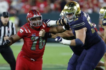 Sep 6, 2026; Green Bay, Wisconsin, USA;  Wisconsin Badgers defensive line Dillan Johnson (76) attempts  to apply pressure at Lambeau Field.  Mandatory Credit: Michael Caterina-Imagn Images