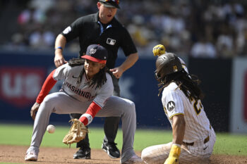 Sep 7, 2026; San Diego, California, USA;  San Diego Padres right fielder Fernando Tatis Jr. (23) steals second base ahead of the throw to Washington Nationals shortstop CJ Abrams (5) during the fourth inning at Petco Park.  Mandatory Credit: Denis Poroy-Imagn Images