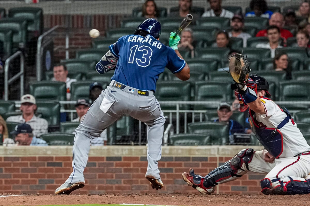 Sep 8, 2026; Cumberland, Georgia, USA; Tampa Bay Rays third baseman Junior Caminero (13) is hit by a pitch against the Atlanta Braves during the eighth inning at Truist Park. Mandatory Credit: Dale Zanine-Imagn Images