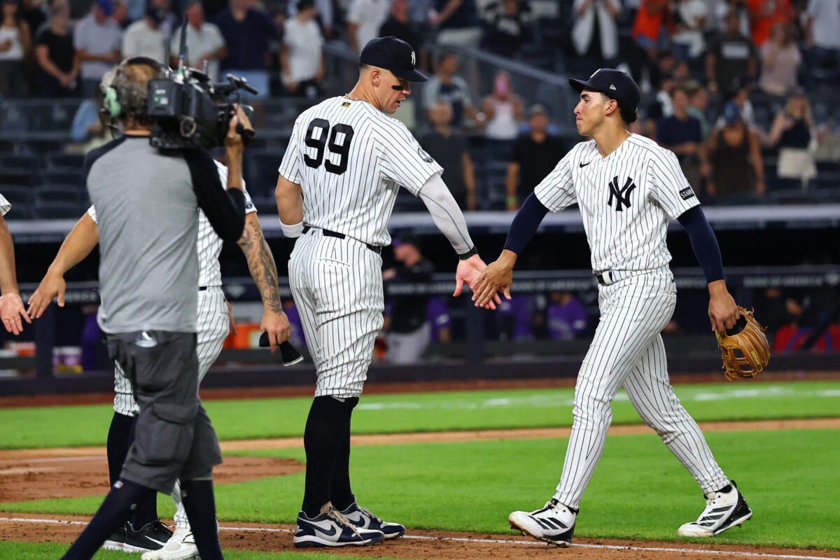 Sep 9, 2026; Bronx, New York, USA;  New York Yankees right fielder Aaron Judge (99) and shortstop George Lombard Jr. (96) celebrate after defeating the Colorado Rockies at Yankee Stadium.  Mandatory Credit: Vincent Carchietta-Imagn Images