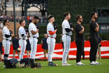 Sep 11, 2026; Detroit, Michigan, USA;  Members of the Detroit Tigers stand for a moment of silence on the 25th anniversary of 9/11 before their game against the Colorado Rockies at Comerica Park.  Mandatory Credit: Lon Horwedel-Imagn Images