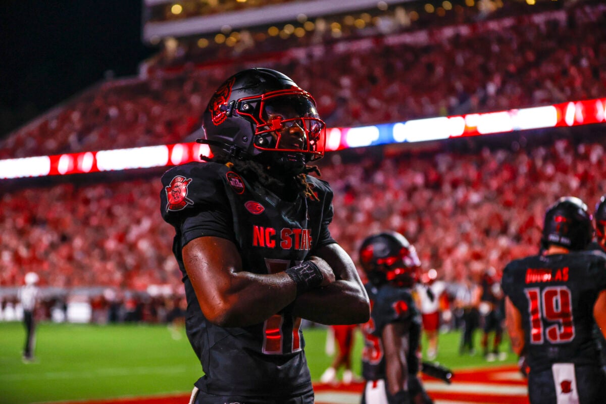 Sep 11, 2026; Raleigh, North Carolina, USA;  NC State Wolfpack quarterback CJ Bailey (11) celebrates a touchdown during the first half of the game against Richmond Spiders at Carter-Finley Stadium.  Mandatory Credit: Jaylynn Nash-Imagn Images