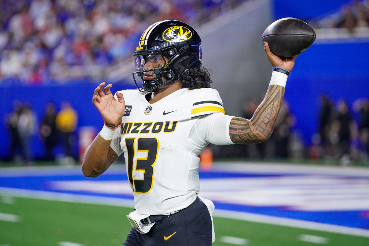 Sep 11, 2026; Lawrence, Kansas, USA; Missouri Tigers quarterback Austin Simmons (13) warms up on the sidelines against the Kansas Jayhawks during the second half of the game at David Booth Kansas Memorial Stadium. Mandatory Credit: Denny Medley-Imagn Images