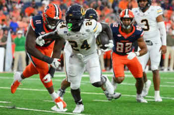Sep 12, 2026; Syracuse, New York, USA;  California Golden Bears running back Adam Mohammed (24) runs with the ball past Syracuse Orange defensive lineman Nissi Ogbebor (11) during the second half at the JMA Wireless Dome.  Mandatory Credit: Rich Barnes-Imagn Images