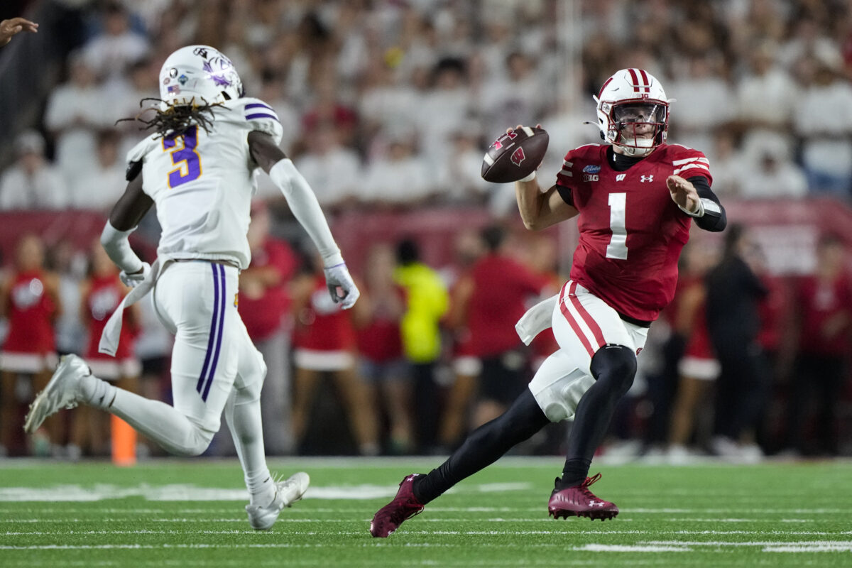 Sep 12, 2026; Madison, Wisconsin, USA;  Wisconsin Badgers quarterback Colton Joseph (1) looks to throw a pass under pressure from Western Illinois Leathernecks defensive back Aa'zoriyon Bonner (3) during the third quarter at Camp Randall Stadium. Mandatory Credit: Jeff Hanisch-Imagn Images