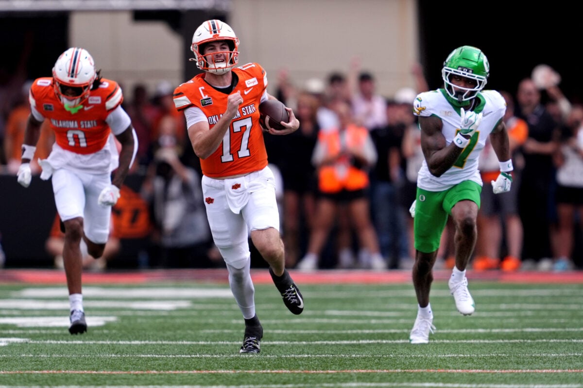 Oklahoma State's Drew Mestemaker (17) rushes as Oregon's Ify Obidegwu (7) defends in the first half of the college football game between the Oklahoma State Cowboys and the Oregon Ducks at Boone Pickens Stadium in Stillwater, Okla., Saturday, Sept., 12, 2026.