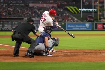 Sep 14, 2026; Anaheim, California, USA; Los Angeles Angels designated hitter Mike Trout (27) bats in the fifth inning as Seattle Mariners catcher Cal Raleigh (29) and home plate umpire Chad Whitson watch at Angel Stadium. Mandatory Credit: Kirby Lee-Imagn Images