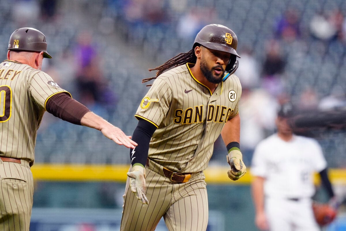 Sep. 15, 2026;  Denver, Colorado, USA: San Diego Padres right fielder Fernando Tatis Jr. (23) celebrates his solo home run with third base coach Bob Henley (20) in the first inning against the Colorado Rockies at Coors Field.  Mandatory Credit: Ron Chenoy-Imagn Images.