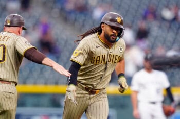 Sep. 15, 2026;  Denver, Colorado, USA: San Diego Padres right fielder Fernando Tatis Jr. (23) celebrates his solo home run with third base coach Bob Henley (20) in the first inning against the Colorado Rockies at Coors Field.  Mandatory Credit: Ron Chenoy-Imagn Images.