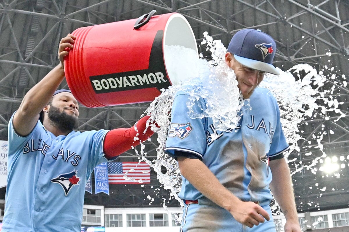 Sep 16, 2026; Toronto, Ontario, CAN;  Toronto Blue Jays left fielder Myles Straw (3) gets doused with ice water by first baseman Vladimir Guerrero Jr. (27) as they celebrate a win over the Detroit Tigers at Rogers Centre.  Mandatory Credit: Dan Hamilton-Imagn Images