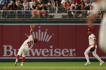 Sep 16, 2026; Washington, District of Columbia, USA; Washington Nationals second baseman Nasim Nuñez (26) reaches to catch a pop up by Philadelphia Phillies shortstop Trea Turner (not pictured) during the seventh inning at Nationals Park. Mandatory Credit: Geoff Burke-Imagn Images
