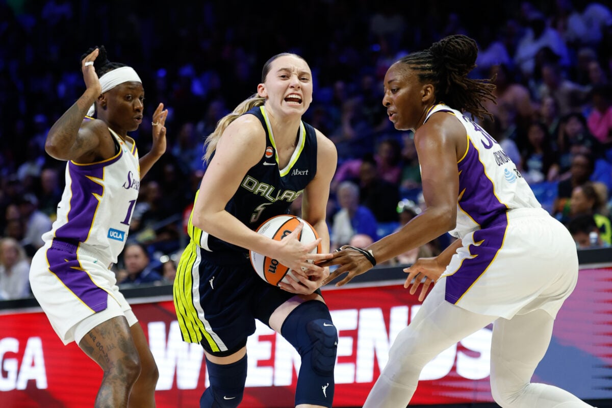 Sep 17, 2026; Arlington, Texas, USA;  Dallas Wings guard Paige Bueckers (5) drives between Los Angeles Sparks guard Erica Wheeler (17) and forward Nneka Ogwumike (30) during the second half at College Park Center.  Mandatory Credit: Chris Jones-Imagn Images