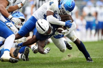 Sep 19, 2026; University Park, Pennsylvania, USA;  Penn State Nittany Lions running back Cam Wallace (26) pushes forward with the ball before being tackled by Buffalo Bulls safety Ronnell Davis (4) during the fourth quarter of the game at West Shore Home Field at Beaver Stadium.  Mandatory Credit: Matthew O'Haren-Imagn Images