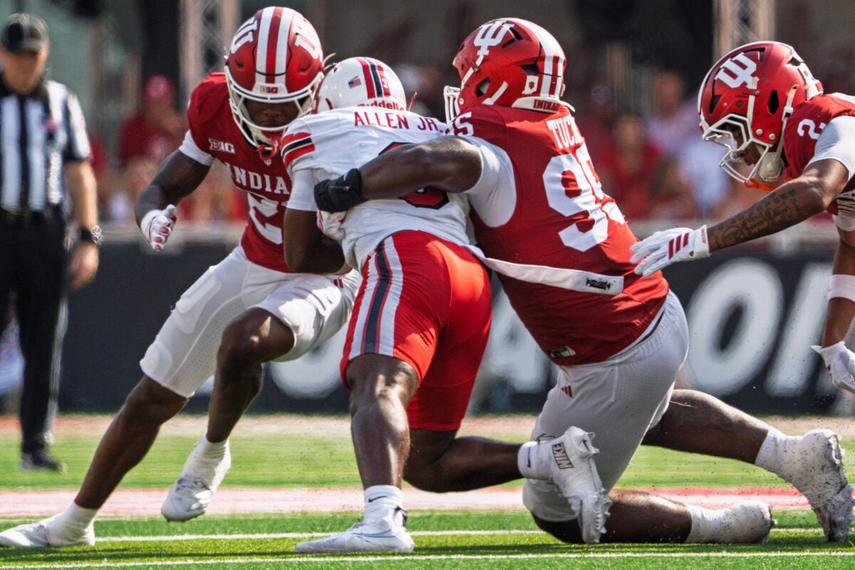 Indiana's Tyrique Tucker (95) and Jamari Sharpe (22) tackle Western Kentucky's Ajay Allen (3) during the Indiana versus Western Kentucky football game at Memorial Stadium on Saturday, Sept. 19, 2026.