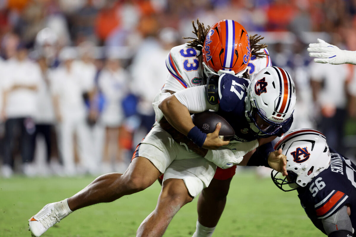 Sep 19, 2026; Auburn, Alabama, USA; Auburn Tigers quarterback Byrum Brown (17) is sacked by Florida Gators defensive lineman Dk Kalu (93) during the fourth quarter at Jordan-Hare Stadium. Mandatory Credit: John Reed-Imagn Images
