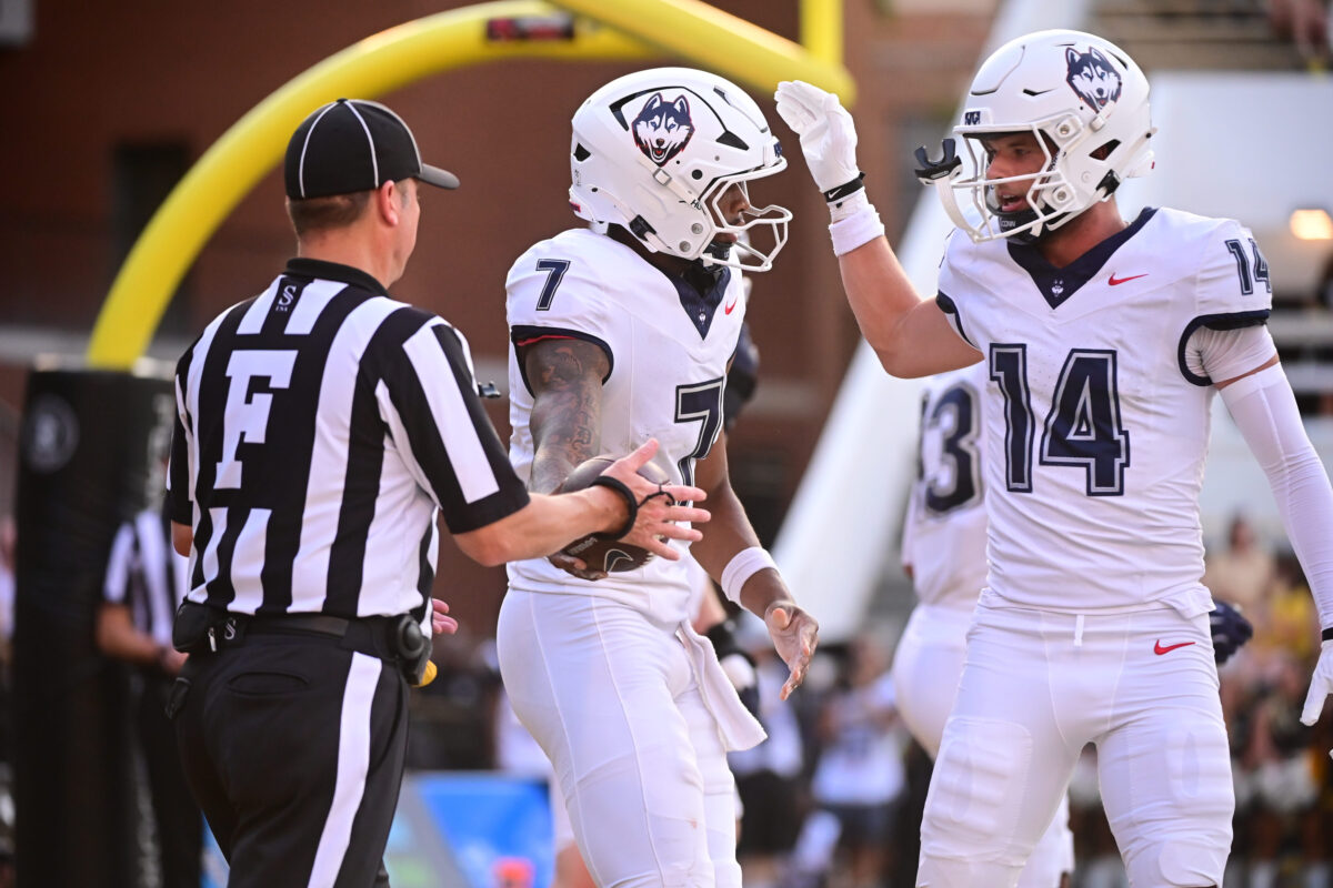 UConn Huskies quarterback Kalieb Osborne (7) reacts with teammates after a touchdown during the college football game between the Southern Miss Golden Eagles and the UConn Huskies at Carlisle-Faulkner Field at Renasant Stadium in Hattiesburg. Photo by Matt Bush.