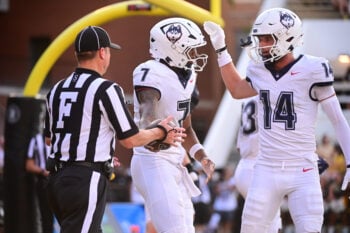 UConn Huskies quarterback Kalieb Osborne (7) reacts with teammates after a touchdown during the college football game between the Southern Miss Golden Eagles and the UConn Huskies at Carlisle-Faulkner Field at Renasant Stadium in Hattiesburg. Photo by Matt Bush.