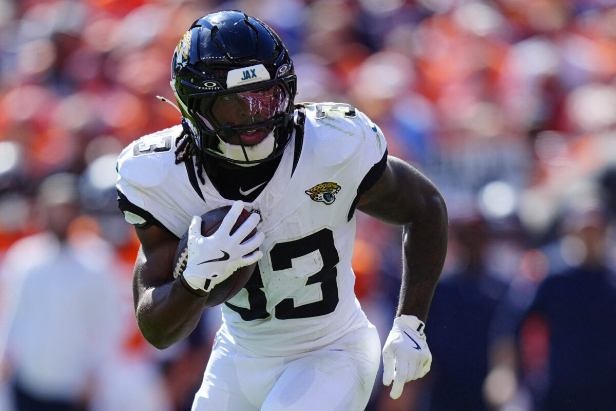 Sep 20, 2026; Denver, Colorado, USA;  Jacksonville Jaguars running back Bhayshul Tuten (33) rushes the ball against the Denver Broncos in the first half at Empower Field at Mile High.  Mandatory Credit: Ron Chenoy-Imagn Images