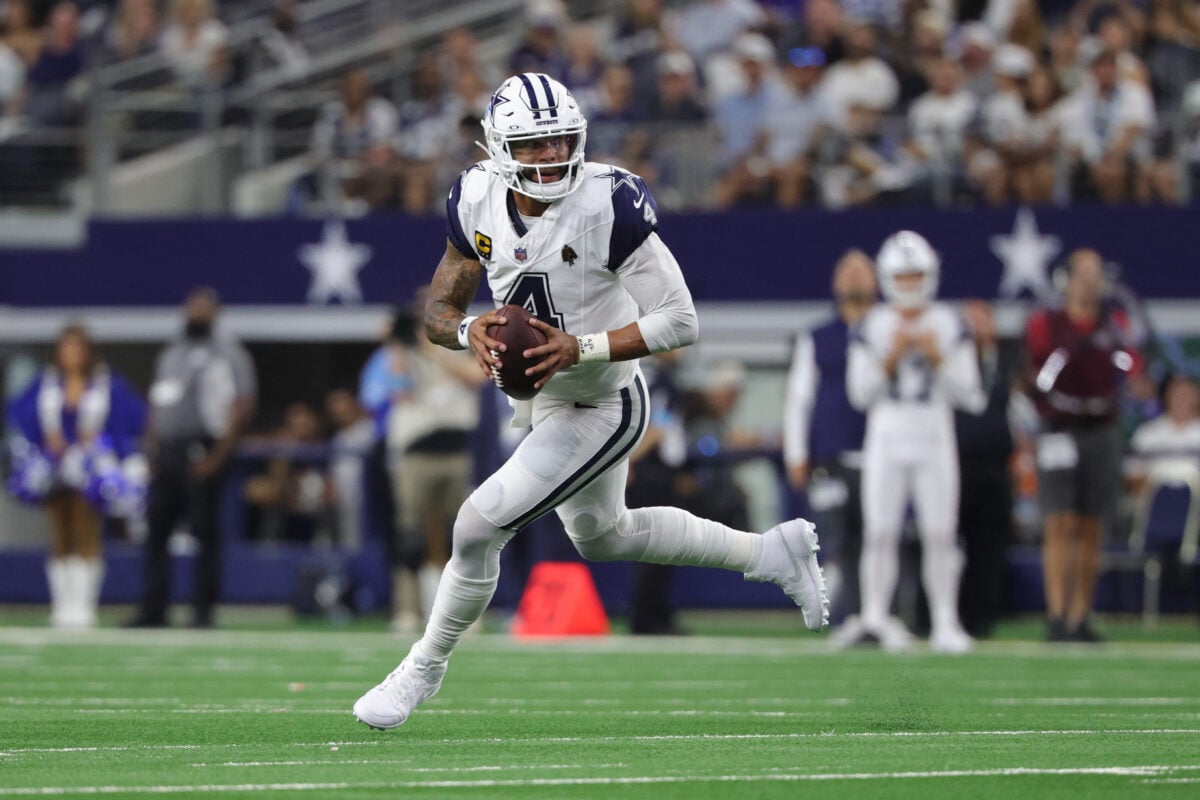 Sep 20, 2026; Arlington, Texas, USA;  Dallas Cowboys quarterback Dak Prescott (4) scrambles against the Washington Commanders defense during the first half at AT&T Stadium.  Mandatory Credit: Kevin Jairaj-Imagn Images