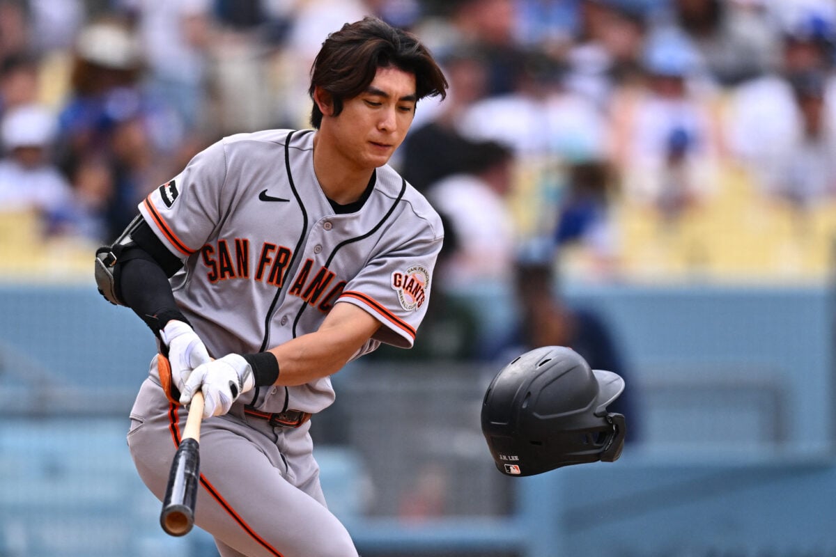 Sep 20, 2026; Los Angeles, California, USA; San Francisco Giants outfielder Jung Hoo Lee (51) knocks his helmet off during a foul ball in the sixth inning against the Los Angeles Dodgers at Dodger Stadium. Mandatory Credit: William Liang-Imagn Images