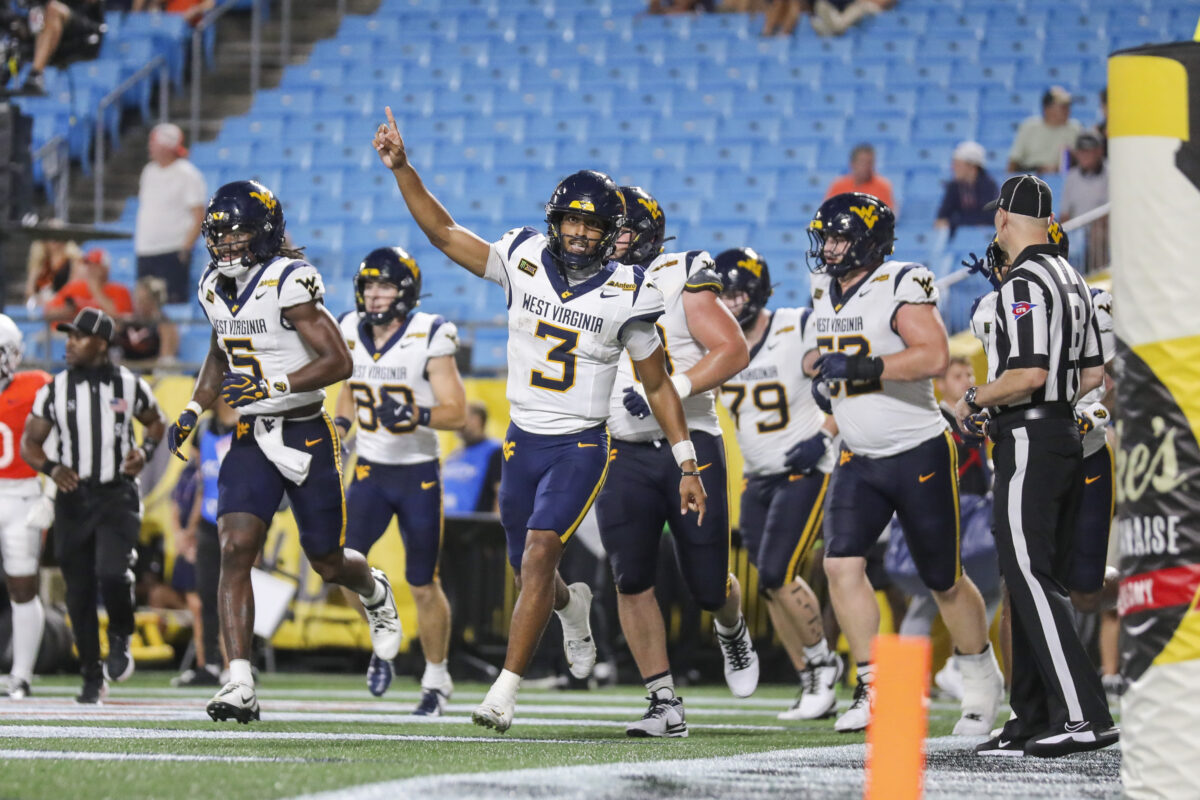 Sep 19, 2026; Charlotte, North Carolina, USA; West Virginia Mountaineers quarterback Michael Hawkins Jr. (3) celebrates after a touchdown during the second quarter Virginia Cavaliers at Bank of America Stadium. Mandatory Credit: Ben Queen-Imagn Images