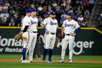 Sep 22, 2026; Arlington, Texas, USA;  Texas Rangers third baseman Josh Jung (6) and shortstop Corey Seager (5) and first baseman Jake Burger (21) and second baseman Justin Foscue (14) look on during the seventh inning against the New York Mets at Globe Life Field. Mandatory Credit: Jerome Miron-Imagn Images