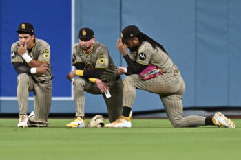 Sep 24, 2026; Los Angeles, California, USA;  San Diego Padres outfield meet during the fifth inning against the Los Angeles Dodgers at Dodger Stadium.  Mandatory Credit: William Liang-Imagn Images
