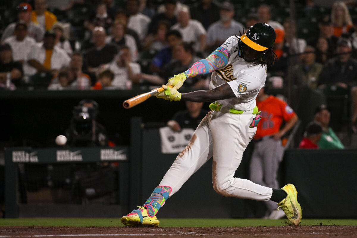 Sep 25, 2026; West Sacramento, California, USA;  Athletics right fielder Lawrence Butler (4) hits a RBI single against the Houston Astros dsixth inning at Sutter Health Park.  Mandatory Credit: Ed Szczepanski-Imagn Images