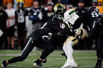 Oct 25, 2025; Laramie, Wyoming, USA; Wyoming Cowboys safety Jones Thomas (23) tackles Colorado State Rams running back Javion Kinnard (24) in the first quarter at Jonah Field at War Memorial Stadium. Mandatory Credit: Ron Chenoy-Imagn Images