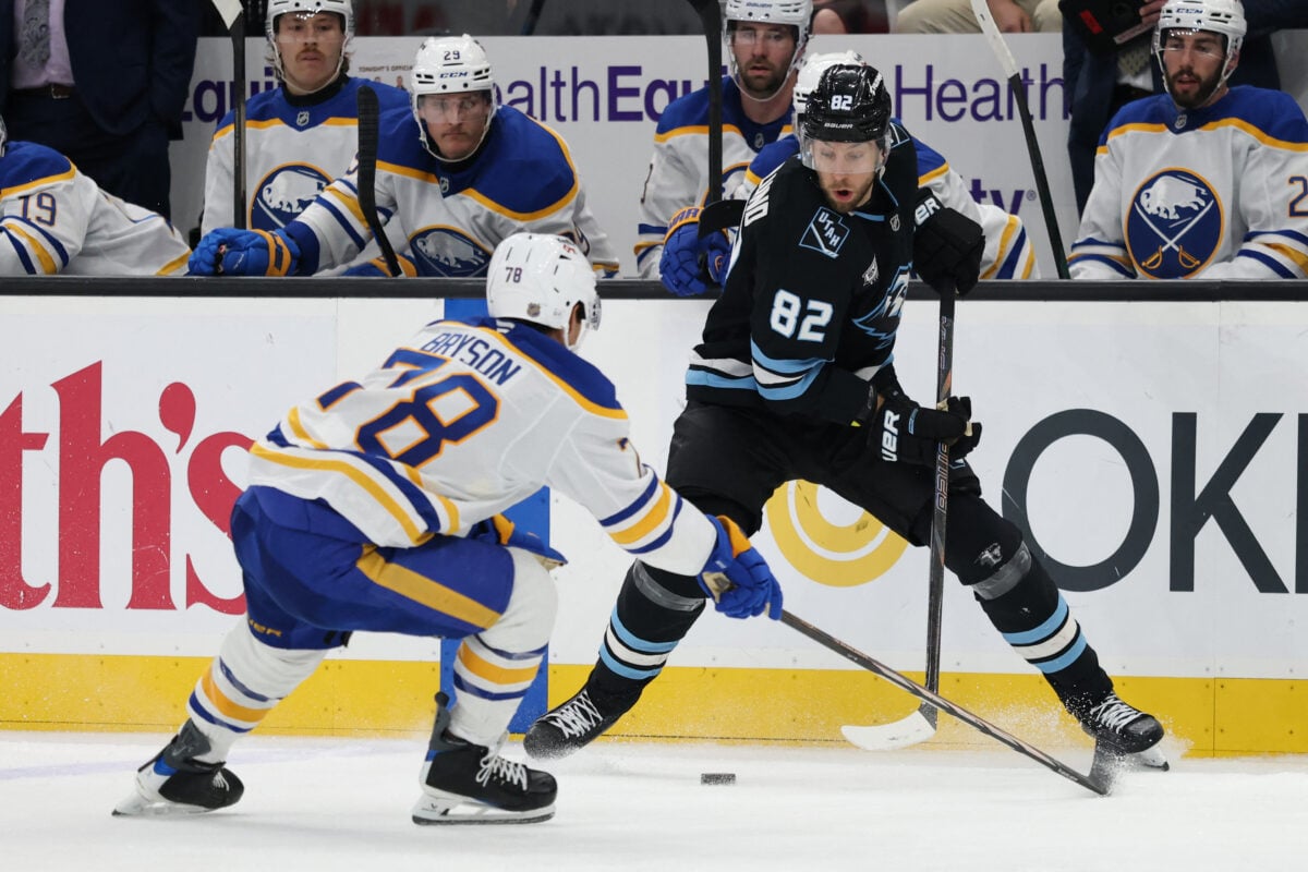 Nov 12, 2025; Salt Lake City, Utah, USA; Utah Mammoth center Kevin Stenlund (82) moves the puck against Buffalo Sabres defenseman Jacob Bryson (78) during the third period at Delta Center. Mandatory Credit: Rob Gray-Imagn Images