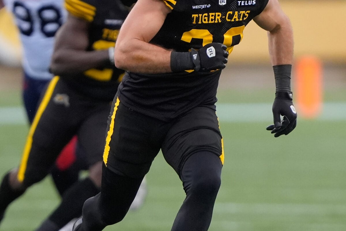 Nov 8, 2025; Hamilton, Ontario, Canada; Hamilton Tiger-Cats linebacker Braxton Hill (38) runs downfield on punt coverage against the Montreal Alouettes during the Eastern Final at Hamilton Stadium. Mandatory Credit: John E. Sokolowski-Imagn Images