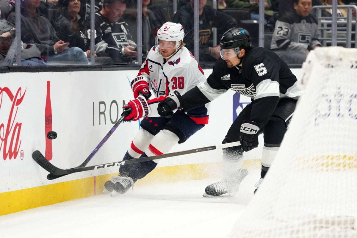 Dec 2, 2025; Los Angeles, California, USA; Washington Capitals defenseman Rasmus Sandin (38) and LA Kings defenseman Cody Ceci (5) battle for the puck in the first period at Crypto.com Arena. Mandatory Credit: Kirby Lee-Imagn Images