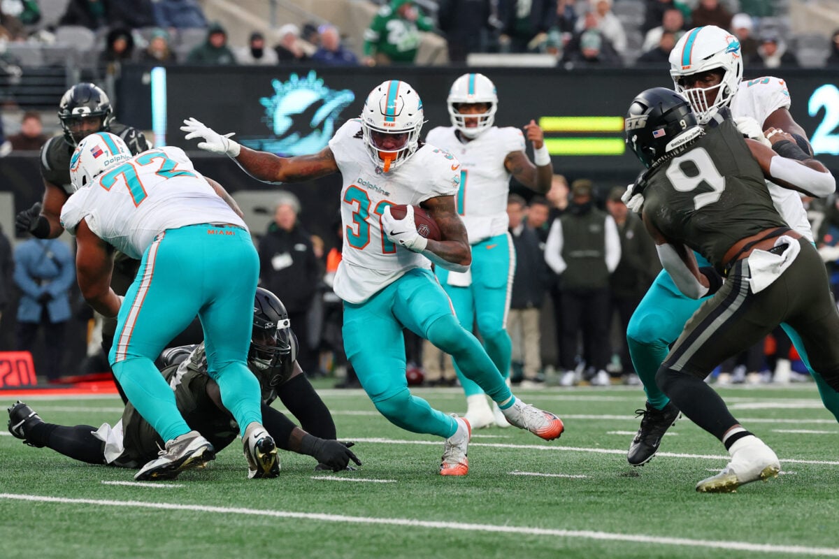 Dec 7, 2025; East Rutherford, New Jersey, USA; Miami Dolphins running back Ollie Gordon II (31) runs with the ball for a touchdown against the New York Jets during the second half at MetLife Stadium. Mandatory Credit: Ed Mulholland-Imagn Images