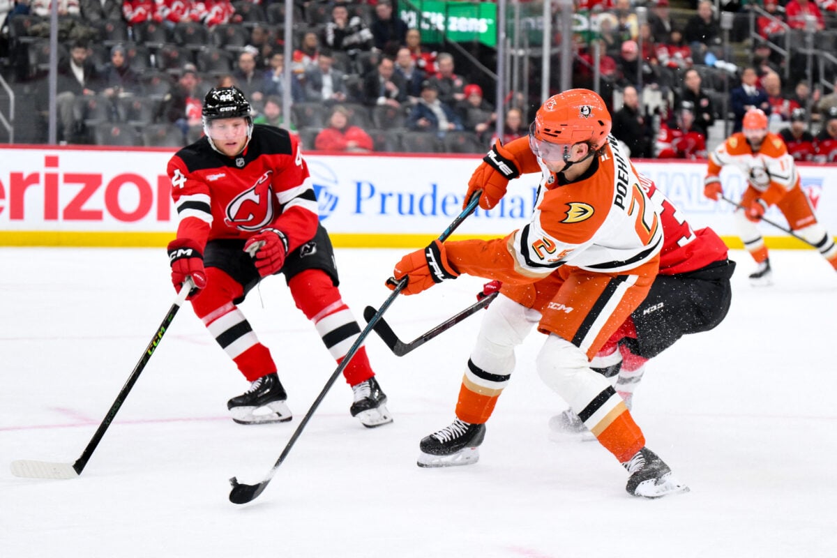 Dec 13, 2025; Newark, New Jersey, USA; Anaheim Ducks center Ryan Poehling (25) shoots against New Jersey Devils defenseman Dennis Cholowski (44) during the third period at Prudential Center. Mandatory Credit: John Jones-Imagn Images
