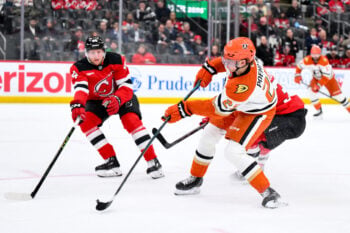 Dec 13, 2025; Newark, New Jersey, USA; Anaheim Ducks center Ryan Poehling (25) shoots against New Jersey Devils defenseman Dennis Cholowski (44) during the third period at Prudential Center. Mandatory Credit: John Jones-Imagn Images