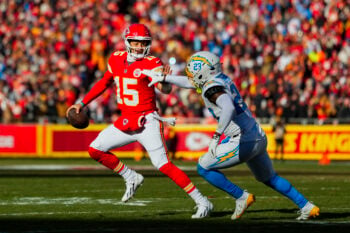 Dec 14, 2025; Kansas City, Missouri, USA; Kansas City Chiefs quarterback Patrick Mahomes (15) scrambles against Los Angeles Chargers safety Tony Jefferson (23) during the first half at GEHA Field at Arrowhead Stadium. Mandatory Credit: Jay Biggerstaff-Imagn Images