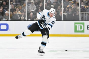 Dec 16, 2025; Boston, Massachusetts, USA; Utah Mammoth defenseman Nate Schmidt (88) fires the puck through the neutral zone during the second period against the Boston Bruins at TD Garden. Mandatory Credit: Eric Canha-Imagn Images