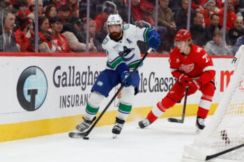 Jan 8, 2026; Detroit, Michigan, USA;  Vancouver Canucks defenseman Filip Hronek (17) skates with the puck in the third period against the Detroit Red Wings at Little Caesars Arena. Mandatory Credit: Rick Osentoski-Imagn Images
