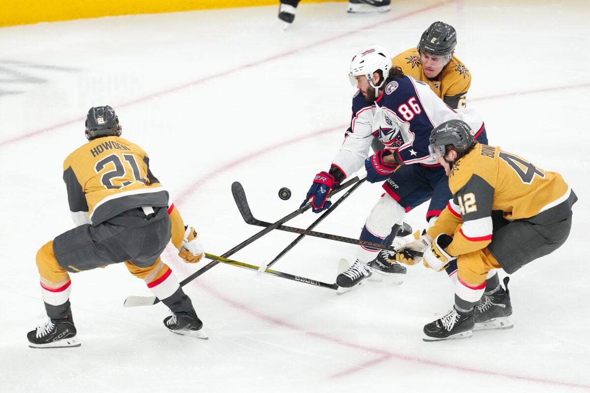 Jan 8, 2026; Las Vegas, Nevada, USA; Columbus Blue Jackets right wing Kirill Marchenko (86) loses control of the puck from a tip by Vegas Golden Knights center Brett Howden (21) as he skates between defenseman Zach Whitecloud (2) and right wing Braeden Bowman (42) during the third period at T-Mobile Arena. Mandatory Credit: Stephen R. Sylvanie-Imagn Images