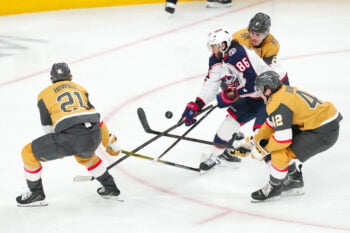 Jan 8, 2026; Las Vegas, Nevada, USA; Columbus Blue Jackets right wing Kirill Marchenko (86) loses control of the puck from a tip by Vegas Golden Knights center Brett Howden (21) as he skates between defenseman Zach Whitecloud (2) and right wing Braeden Bowman (42) during the third period at T-Mobile Arena. Mandatory Credit: Stephen R. Sylvanie-Imagn Images