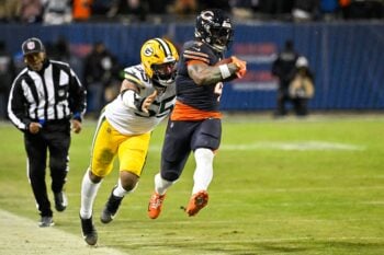 Jan 10, 2026; Chicago, IL, USA; in Chicago Bears running back D'Andre Swift (4) runs with the ball against Green Bay Packers defensive end Kingsley Enagbare (55) during an NFC Wild Card Round game at Soldier Field. Mandatory Credit: Matt Marton-Imagn Images