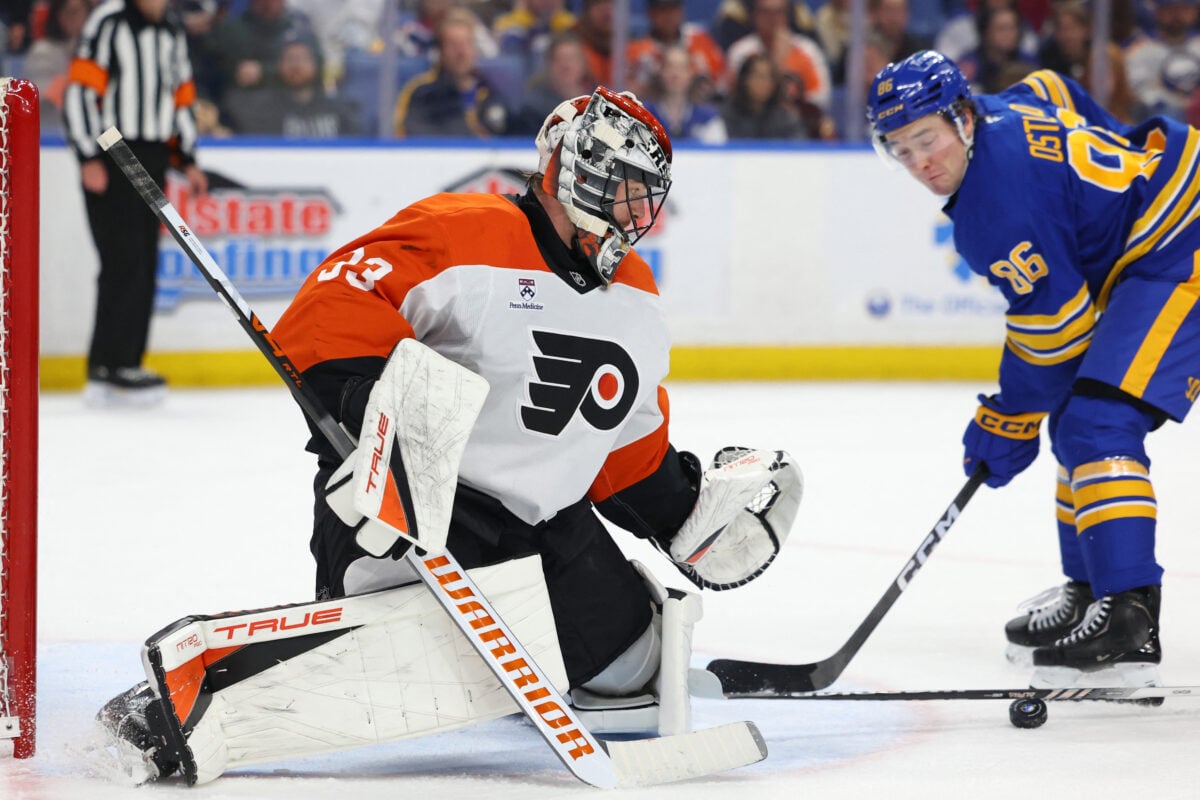 Jan 14, 2026; Buffalo, New York, USA; Philadelphia Flyers goaltender Samuel Ersson (33) looks to cover up the puck during the second period against the Buffalo Sabres at KeyBank Center. Mandatory Credit: Timothy T. Ludwig-Imagn Images
