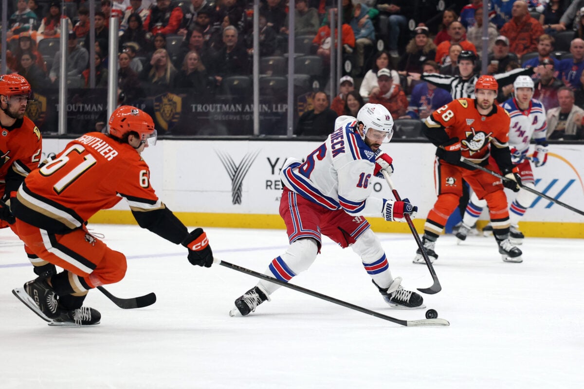 Jan 19, 2026; Anaheim, California, USA; New York Rangers center Vincent Trocheck (16) fights for the puck against Anaheim Ducks left wing Cutter Gauthier (61) during the first period at Honda Center. Mandatory Credit: Kiyoshi Mio-Imagn Images