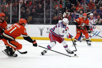 Jan 19, 2026; Anaheim, California, USA;  New York Rangers center Vincent Trocheck (16) fights for the puck against Anaheim Ducks left wing Cutter Gauthier (61) during the first period at Honda Center. Mandatory Credit: Kiyoshi Mio-Imagn Images