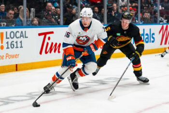 Jan 19, 2026; Vancouver, British Columbia, CAN; Vancouver Canucks defenseman Tom Willander (5) pursues New York Islanders forward Marc Gatcomb (16) in the third period at Rogers Arena. Mandatory Credit: Bob Frid-Imagn Images