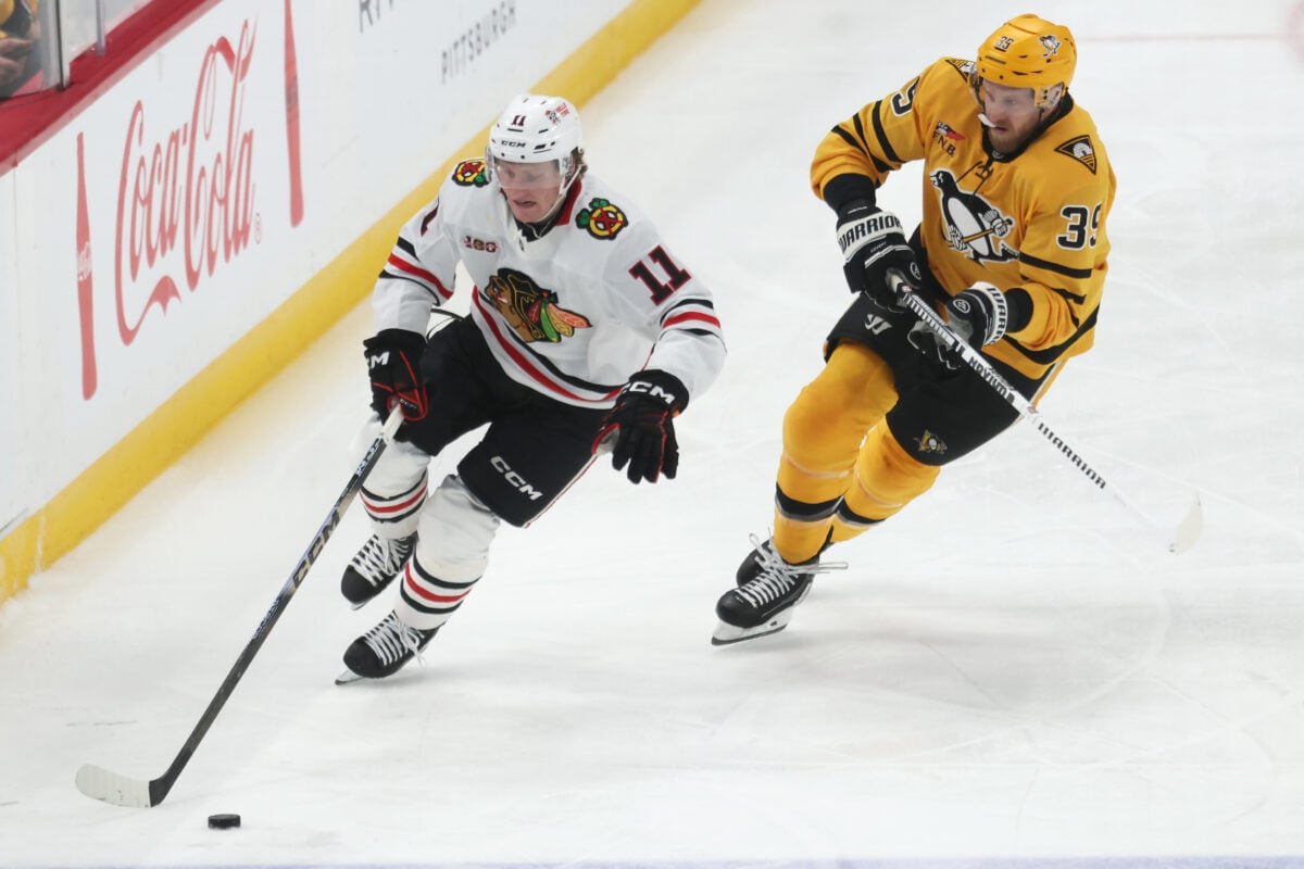Jan 29, 2026; Pittsburgh, Pennsylvania, USA; Chicago Blackhawks center Oliver Moore (11) moves the puck as Pittsburgh Penguins right wing Anthony Mantha (39) chases during the third period at PPG Paints Arena. Mandatory Credit: Charles LeClaire-Imagn Images