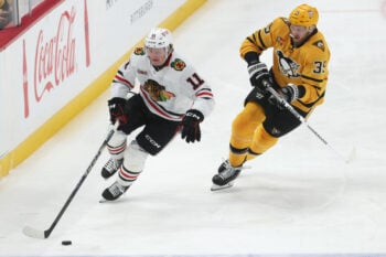 Jan 29, 2026; Pittsburgh, Pennsylvania, USA;  Chicago Blackhawks center Oliver Moore (11) moves the puck as Pittsburgh Penguins right wing Anthony Mantha (39) chases during the third period at PPG Paints Arena. Mandatory Credit: Charles LeClaire-Imagn Images