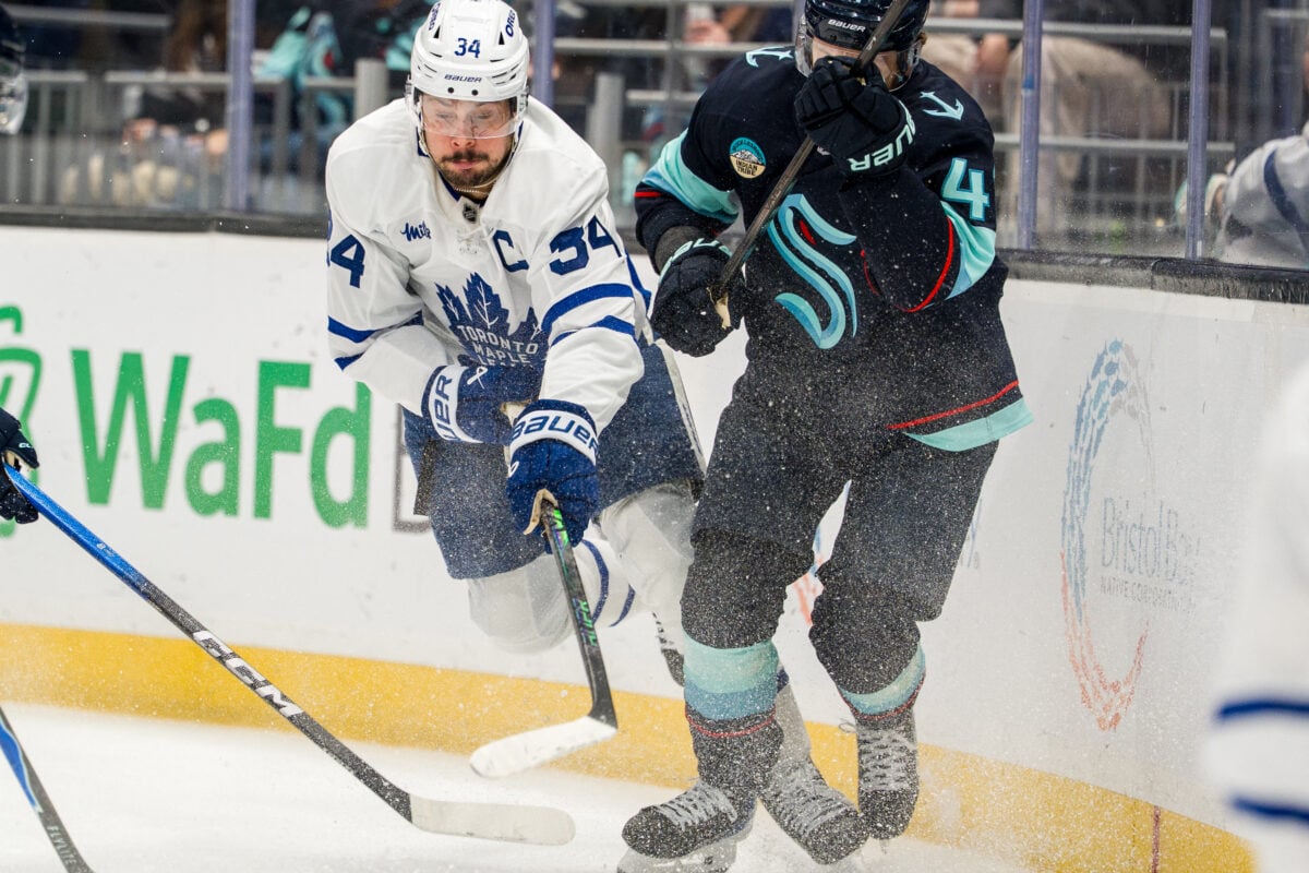 Jan 29, 2026; Seattle, Washington, USA; Toronto Maple Leafs forward Auston Matthews (34) battles Seattle Krakendefenseman Ryker Evans (41) for the puck during the third period at Climate Pledge Arena. Mandatory Credit: Stephen Brashear-Imagn Images