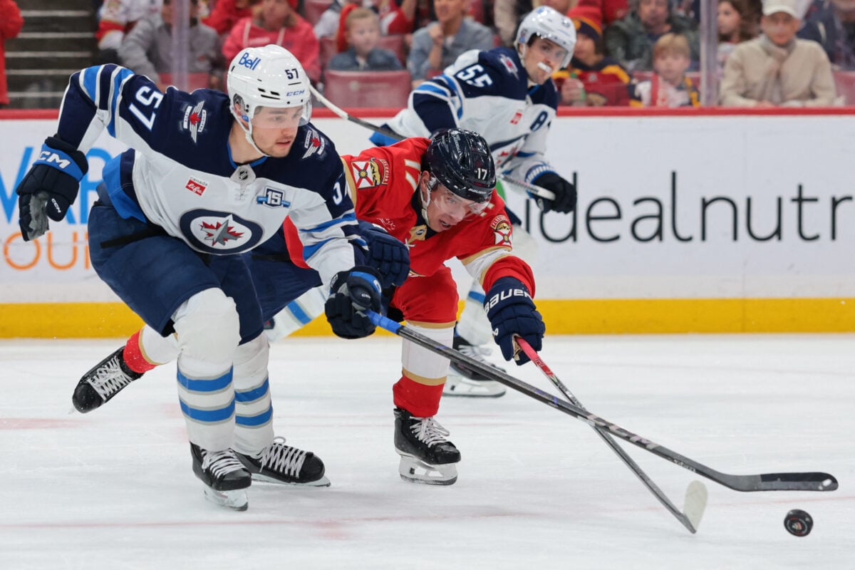 Jan 31, 2026; Sunrise, Florida, USA; Florida Panthers center Evan Rodrigues (17) and Winnipeg Jets defenseman Elias Salomonsson (57) battle for the puck during the second period at Amerant Bank Arena. Mandatory Credit: Sam Navarro-Imagn Images